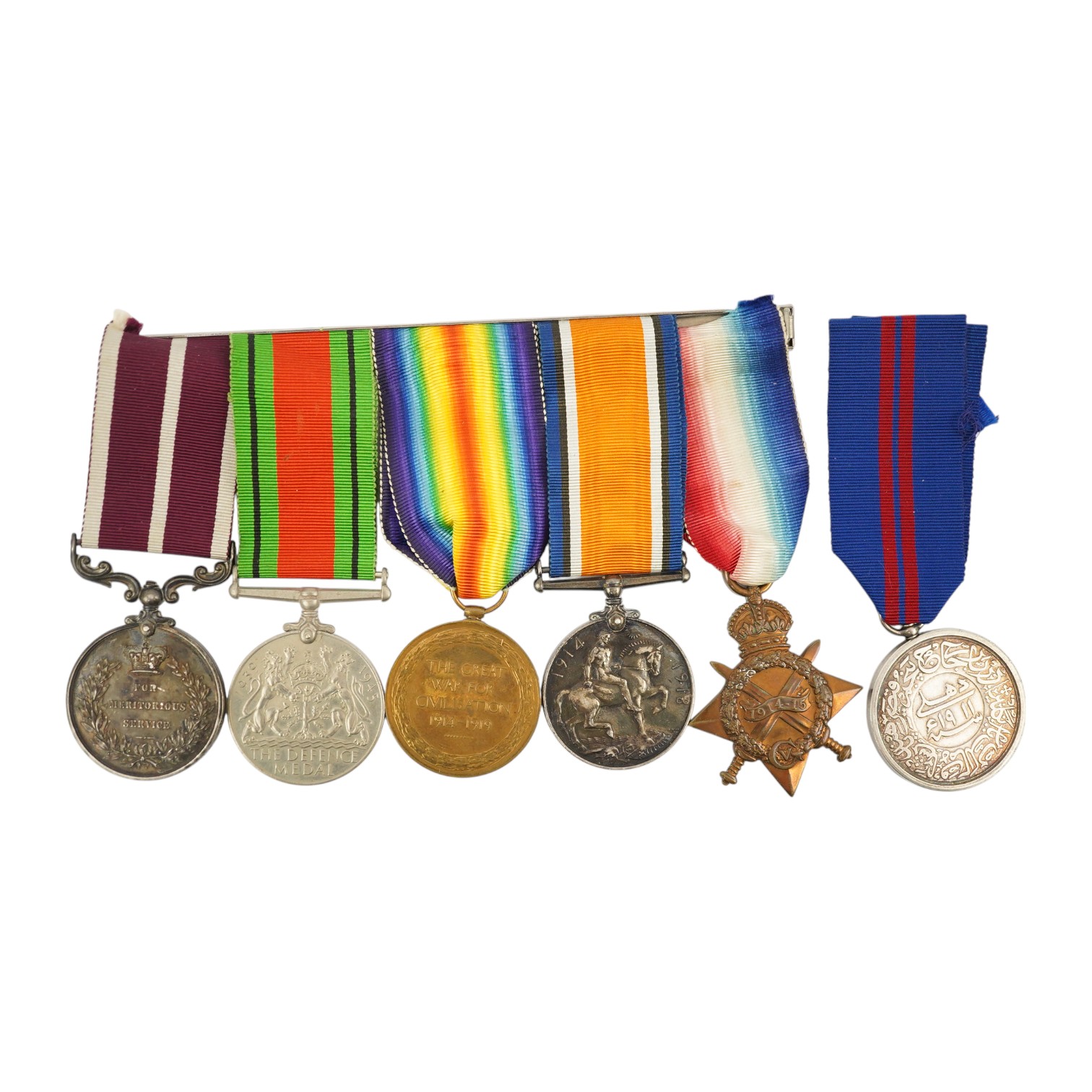 A medal group comprising of a Meritorious Service medal, a 1939 to 1945 Defence Medal, and a First World War trio awarded to 3824 SJT. F.W.G. Wakefield. R.F.A., together with a Delhi Durbar Medal 1911, crudely engraved t